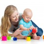 kid boy and mother playing together with cup toys